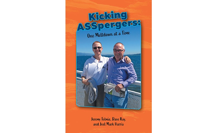 A book cover. The title reads Kicking Aspergers, one meltdown at a time. Jeremy Tolmie, Dave Ray and Joel Mark Harris. The word aspergers is spelt on the cover as A S S P E R G E R S. There are two men in button up shirts standing side by side on a pier by open water with an arm over each others' backs.