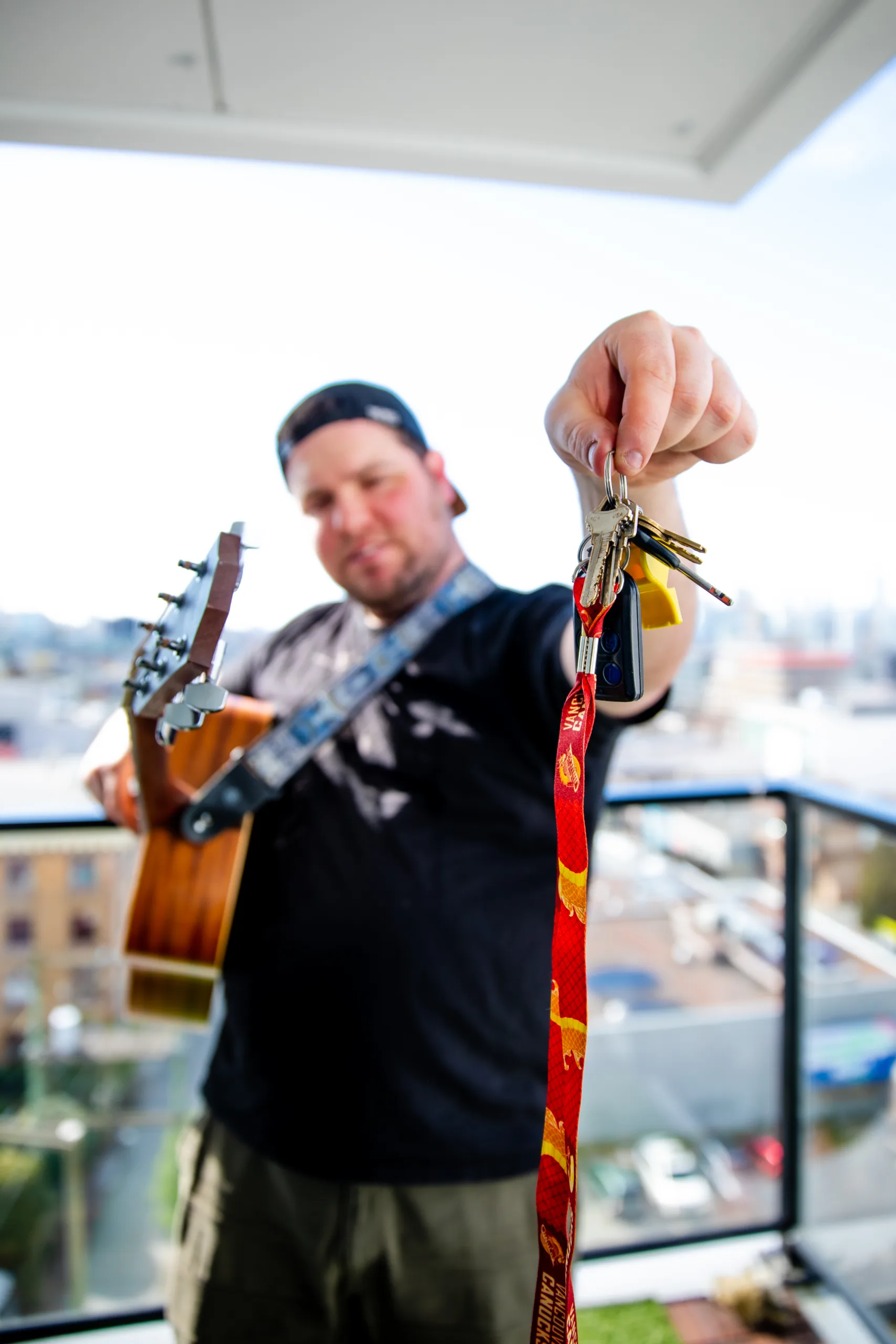 man holding a guitar and keys