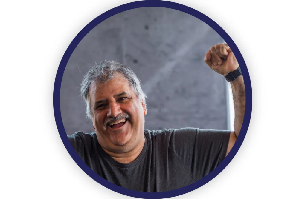 man smiling with his fist in the air