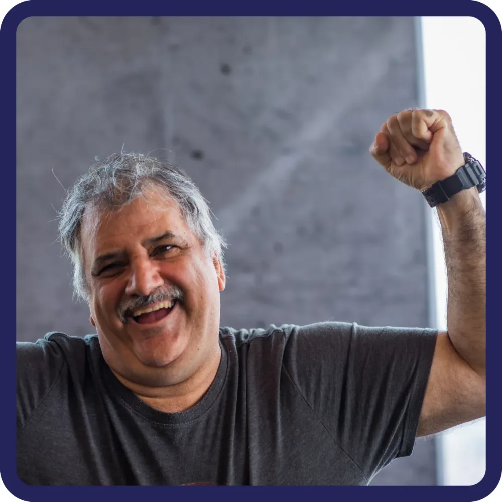 man smiling with his fist in the air