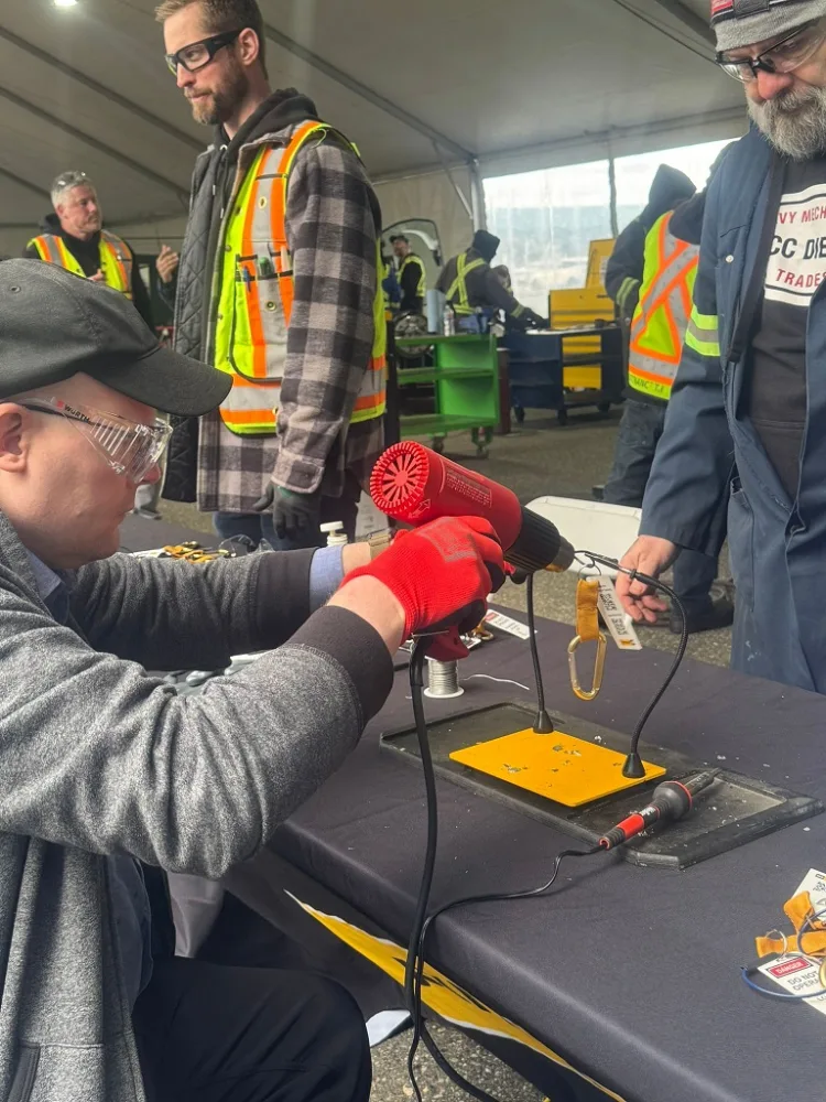 person using a soldering gun